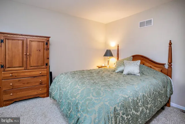 a bedroom with a bed and chair