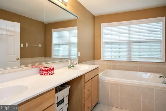a bath tub sitting in a bathroom next to a window