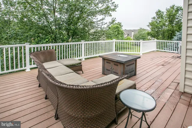 a balcony with wooden floor table and chairs
