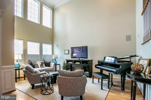 a living room with furniture and a piano
