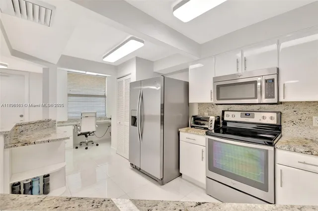 a kitchen with a sink stove and refrigerator