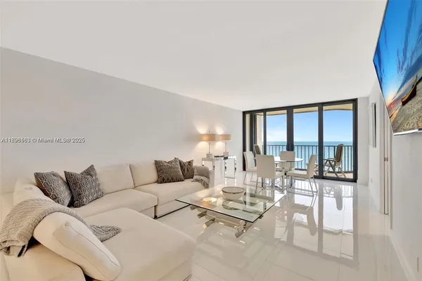 a living room with furniture and a floor to ceiling window
