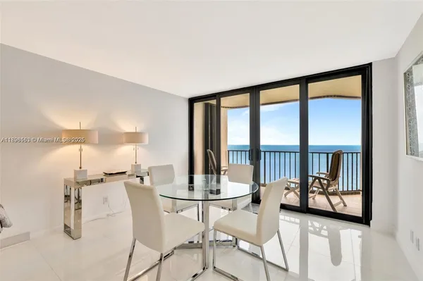 a view of a livingroom with furniture and a floor to ceiling window