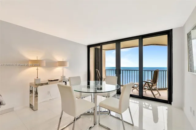 a view of a livingroom with furniture and a floor to ceiling window