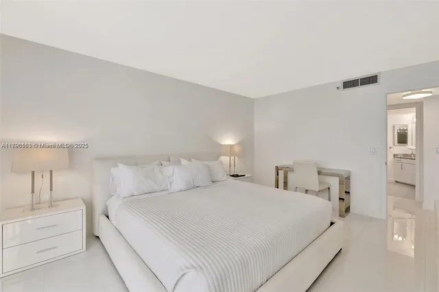 a large white bed in a white room