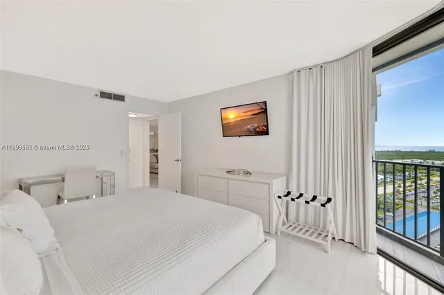 a bedroom with a bed and a tv on the dresser