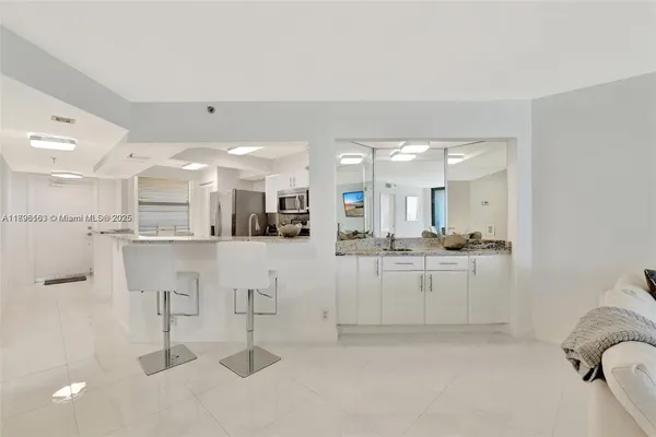 a kitchen with kitchen island cabinets and refrigerator