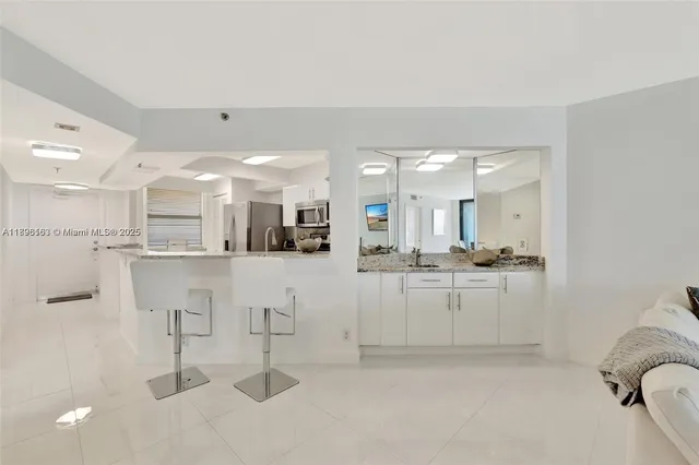 a kitchen with kitchen island cabinets and refrigerator