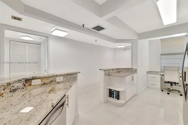 a bathroom with a granite countertop sink mirror and a bathtub
