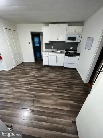 a view of kitchen with microwave and cabinets