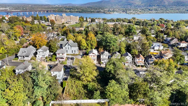 an aerial view of residential house with outdoor space and trees