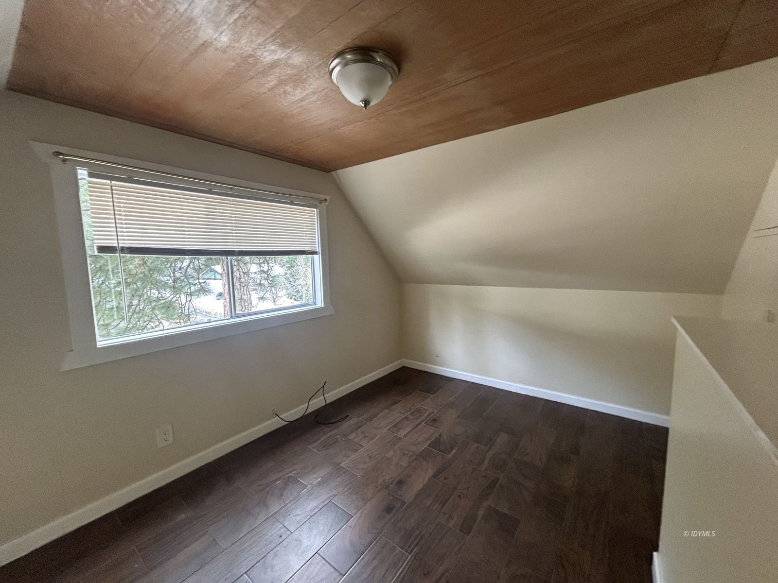 25055 Marion Ridge Drive, Unit 2 Idyllwild, CA 92549 - Photo 12 of 17 an empty room with wooden floor and windows