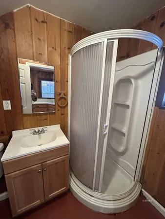 a bathroom with a sink a toilet and mirror