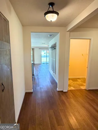 a living room with lots of furniture and a view of kitchen