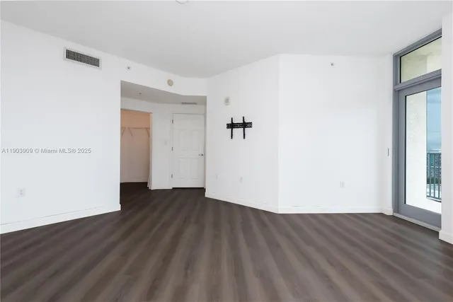 an empty room with wooden floor