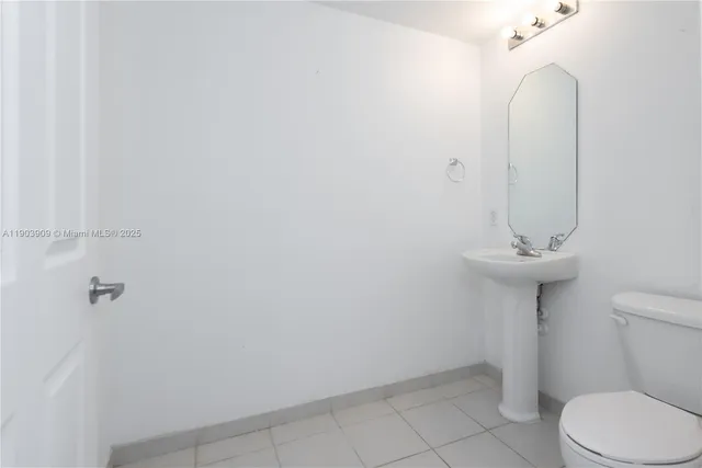 a bathroom with a sink toilet and a mirror