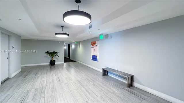 a view of an empty room and wooden floor