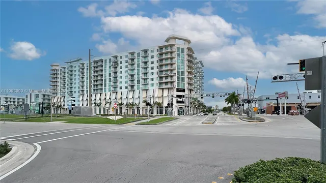 a view of a building with cars parked in front of it