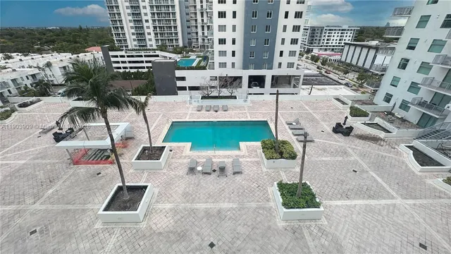 an aerial view of a building with garden and patio