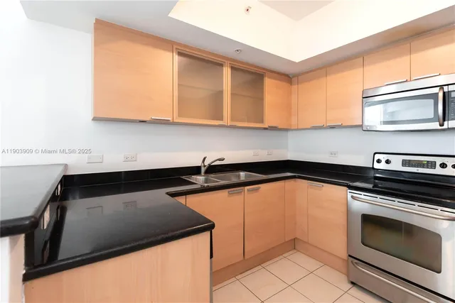 a kitchen with a sink cabinets and stainless steel appliances
