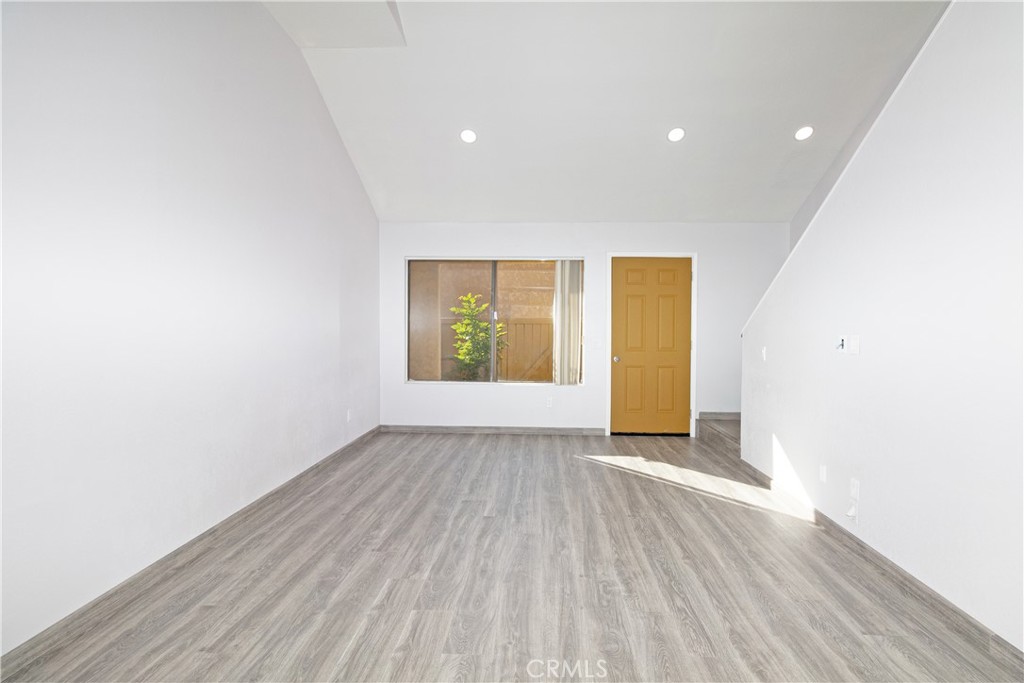 435 West 9th, Unit F5 Upland, CA 91786 - Photo 4 of 23 an empty room with wooden floor and windows