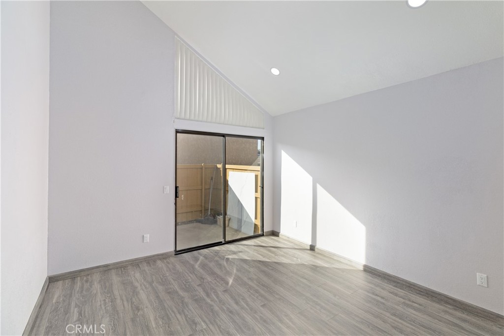 435 West 9th, Unit F5 Upland, CA 91786 - Photo 6 of 23 a view of an empty room with wooden floor and a window