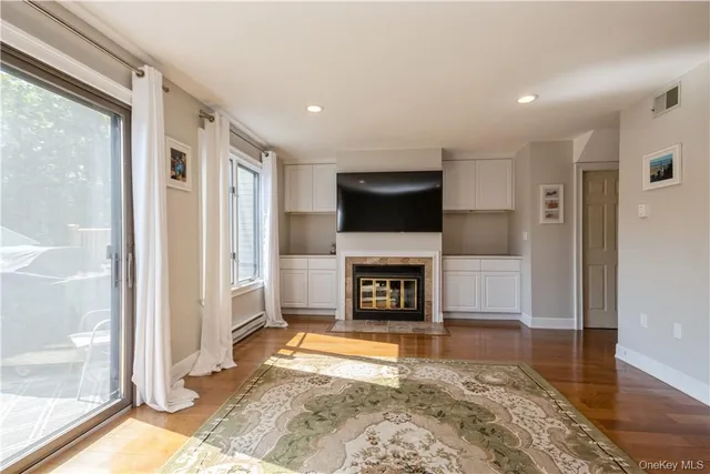 a living room with a fireplace and a flat screen tv