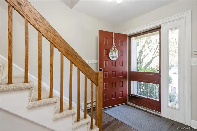 a view of an entryway with wooden floor