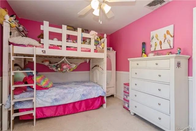 a bedroom with a bed and a white dresser