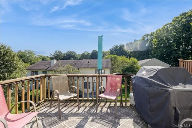 a view of a balcony with two chairs and a table