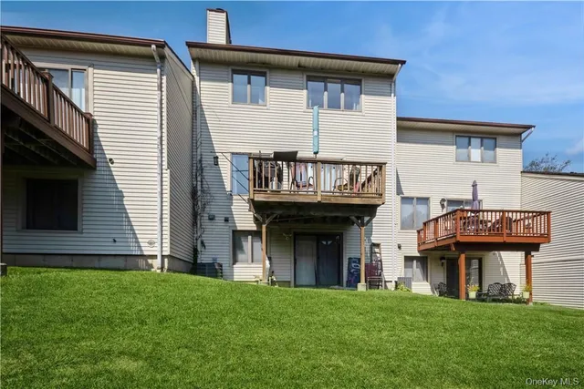 a view of house with yard and outdoor seating