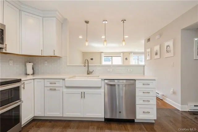 a kitchen with white cabinets stainless steel appliances and sink