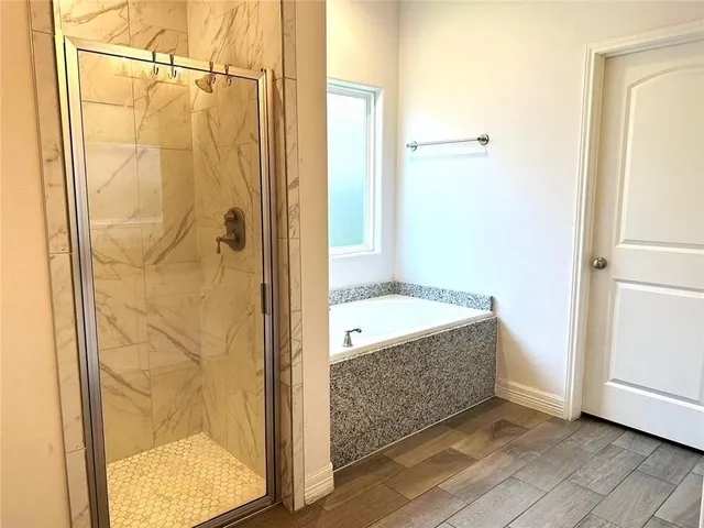 a bathroom with a tub and a shower