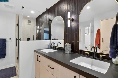 a bathroom with double vanity sinks and a large mirror