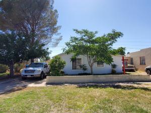 a front view of a house with a garden and yard