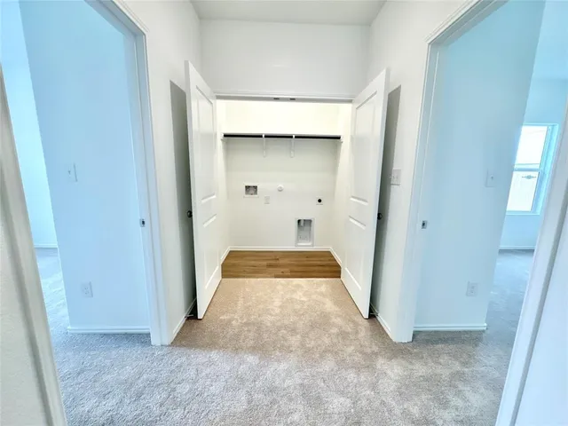 an entryway to room with wooden floor