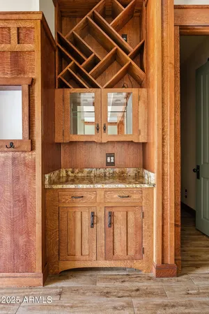 a kitchen with a stove and a white wooden cabinets