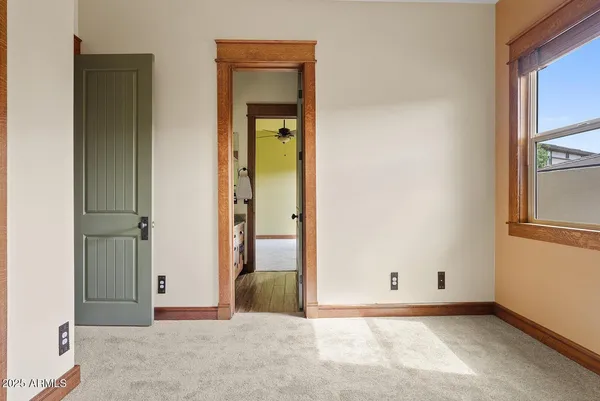 a view of a hallway with wooden shelves