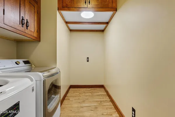 a view of a room with wooden floor and a floor to ceiling window