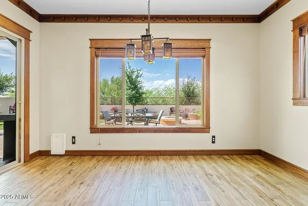 an empty room with a window and a ceiling fan