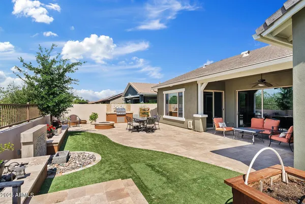 a view of a house with backyard porch and sitting area