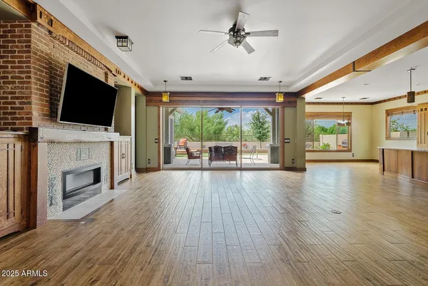 a view of a livingroom with furniture a fireplace and wooden floor