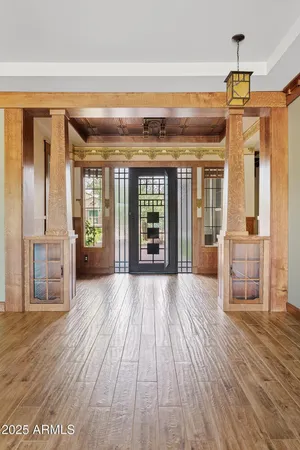 a view of a hallway with wooden floor and a fireplace