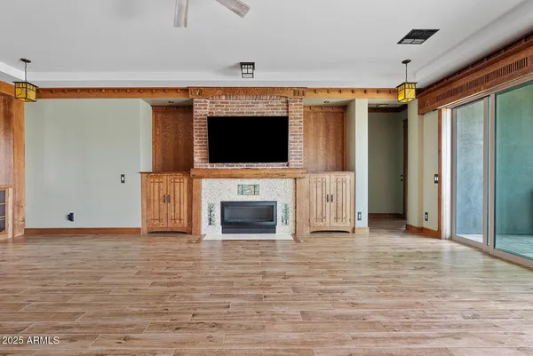 a view of a livingroom with an empty space and a fireplace