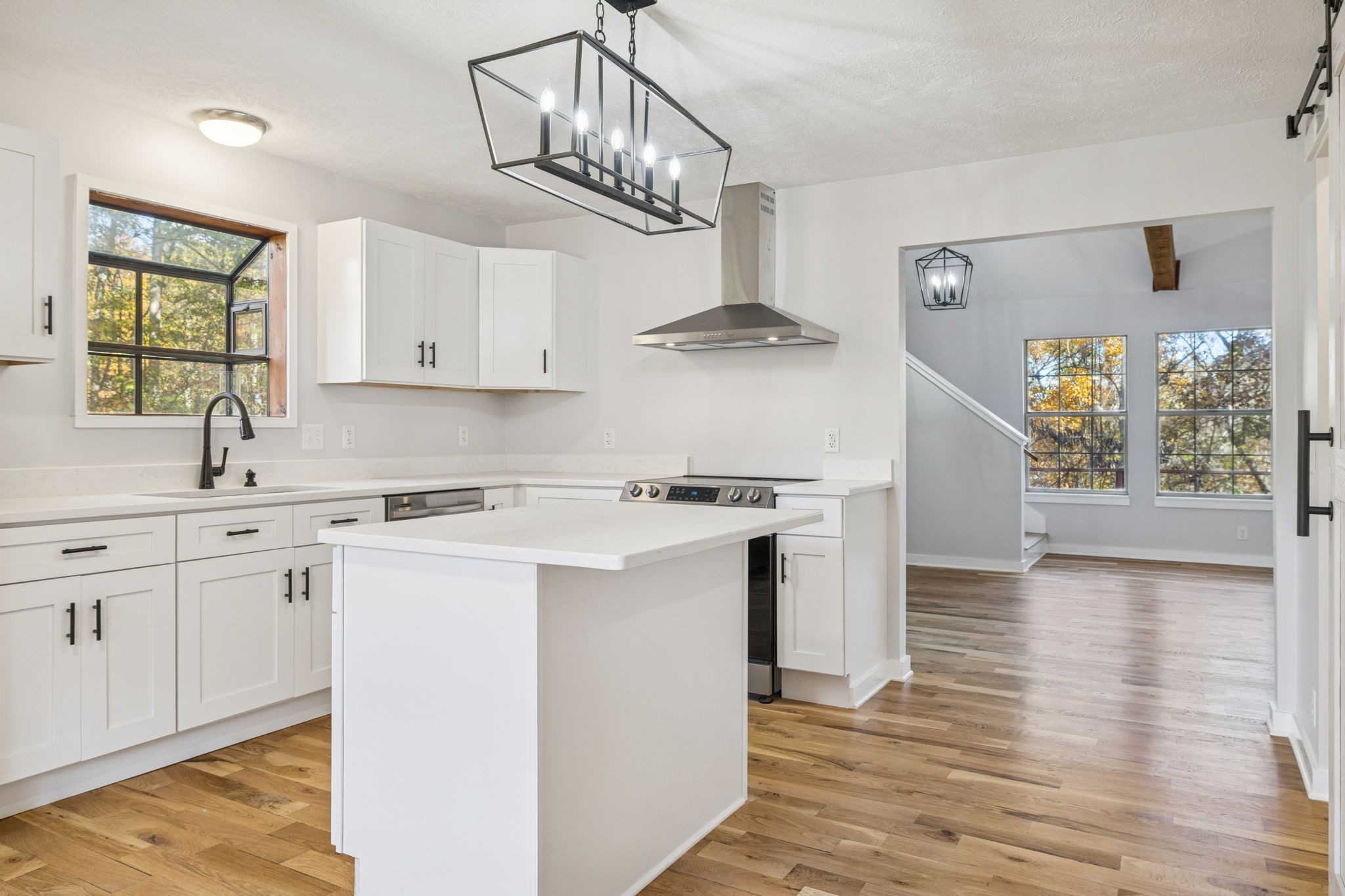 4222 Gourley Road Pegram, TN 37143 - Photo 12 of 76 a kitchen with stainless steel appliances a white stove top oven and a sink with wooden floor