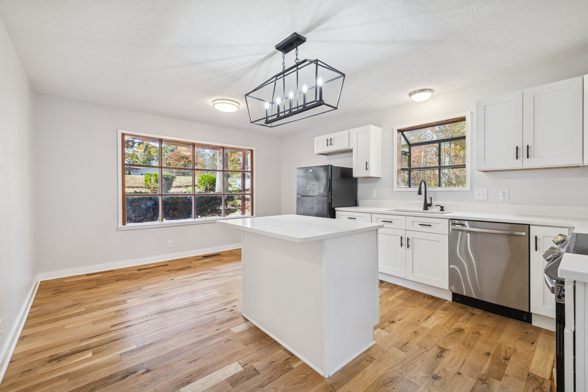 4222 Gourley Road Pegram, TN 37143 - Photo 18 of 76 a kitchen with cabinets wooden floor and a window