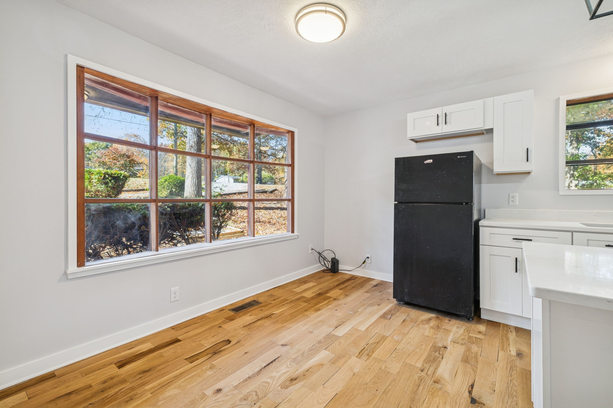 4222 Gourley Road Pegram, TN 37143 - Photo 21 of 76 a view of empty room with wooden floor and refrigerator