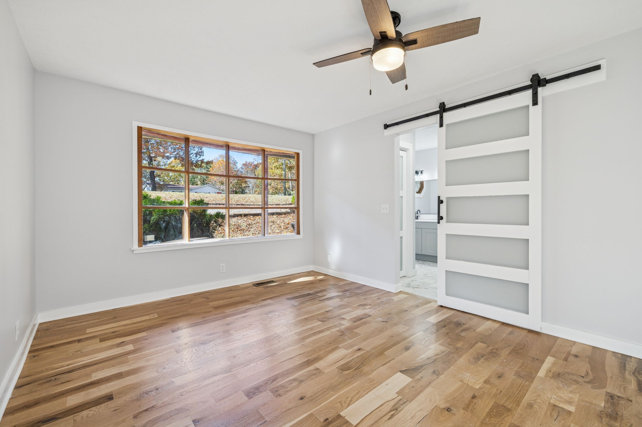 4222 Gourley Road Pegram, TN 37143 - Photo 29 of 76 a view of an empty room with a window and wooden floor