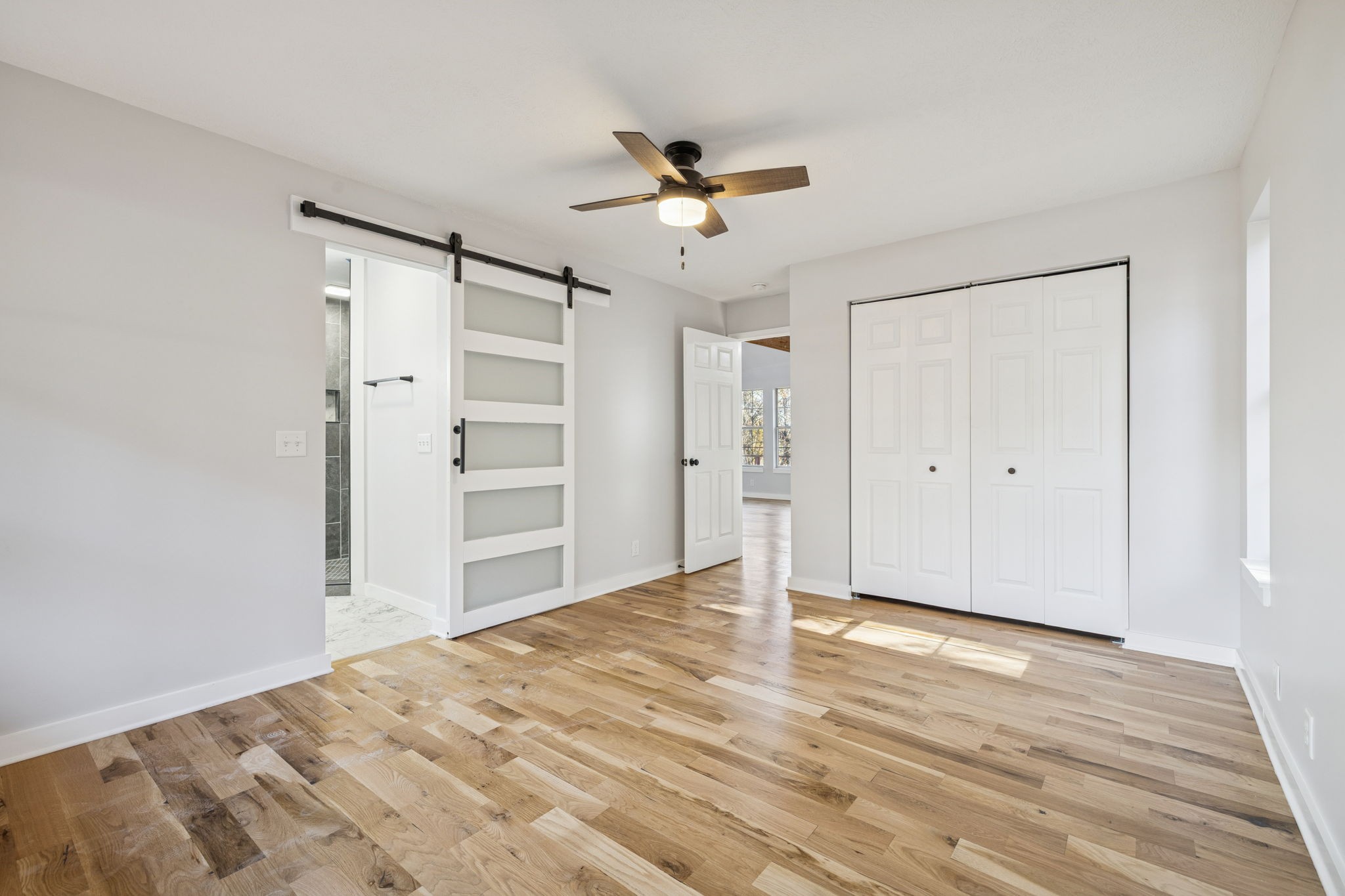 4222 Gourley Road Pegram, TN 37143 - Photo 30 of 76 a view of a livingroom with wooden floor and a ceiling fan