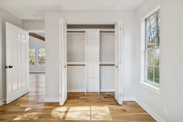a view of an entryway with wooden floor